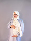 Silver chiffon maternity maxi dress styled over a baby bump
