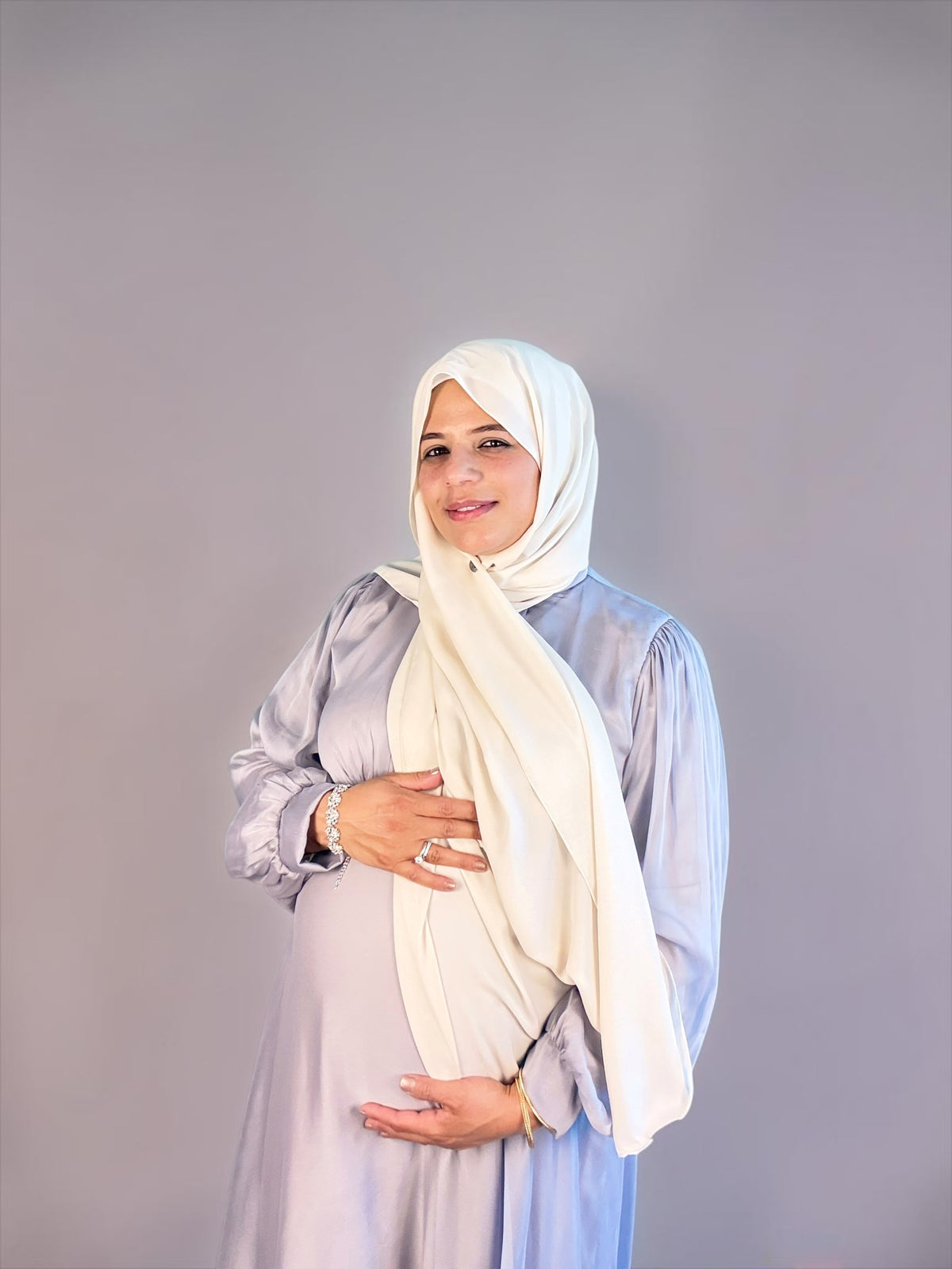 Silver chiffon maternity maxi dress styled over a baby bump