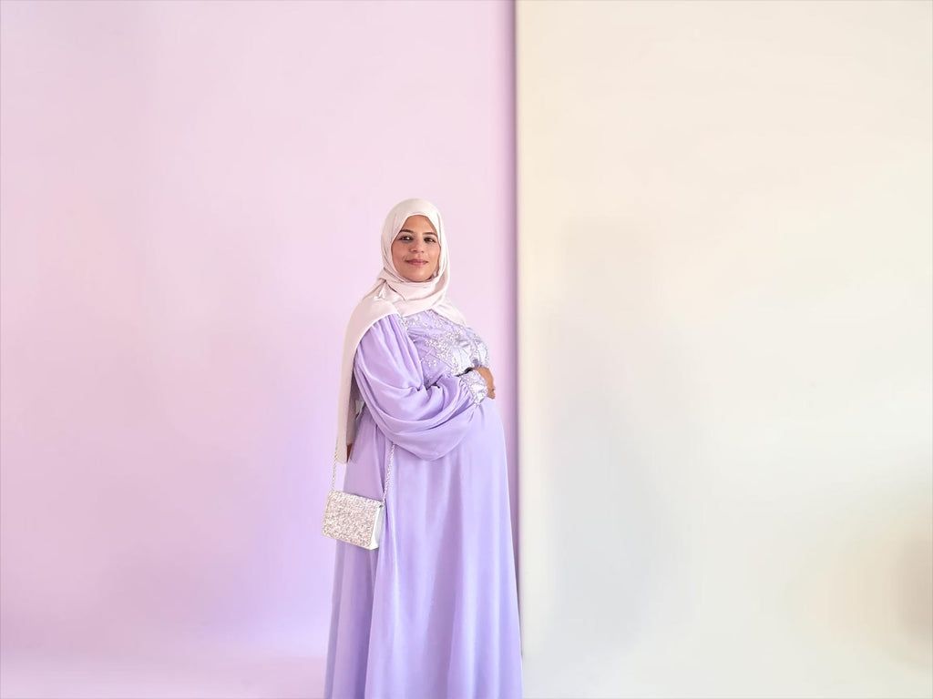 Full-length lavender maternity dress with coordinating accessory