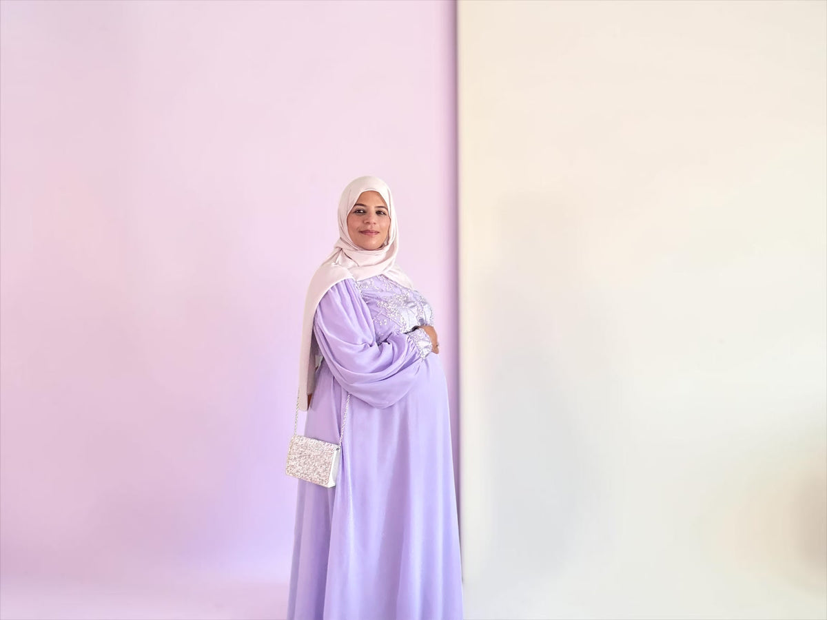 Full-length lavender maternity dress with coordinating accessory