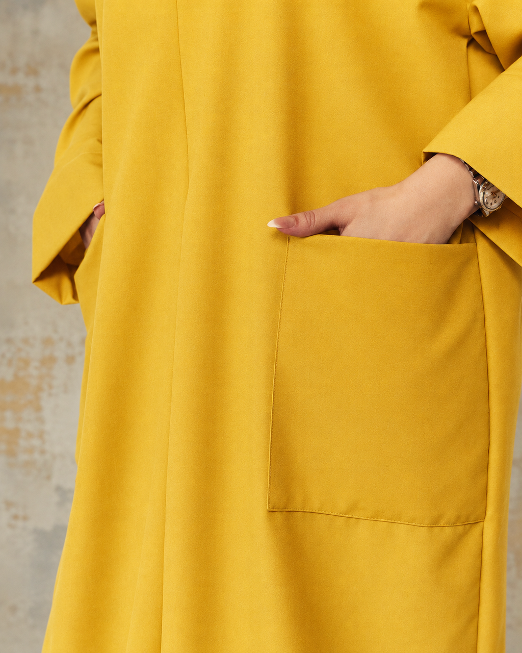 Close-up of pockets on marigold nursing maxi dress